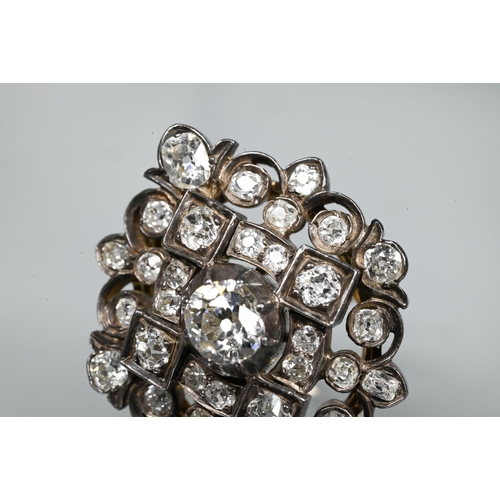 217 - An antique diamond cluster ring, the central old cut diamond sourrounded by a cluster of thirty-two ... 