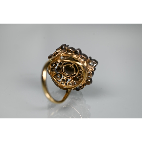 217 - An antique diamond cluster ring, the central old cut diamond sourrounded by a cluster of thirty-two ... 