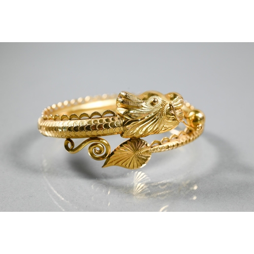 337 - A Chinese yellow gold half-hinged bangle in the form of a coiled dragon chasing the flaming pearl, t... 