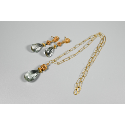 339 - A matching contemporary earring and necklace suite comprising a pear-shaped faceted pale blue stone ... 