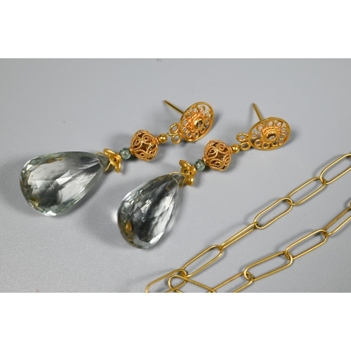 339 - A matching contemporary earring and necklace suite comprising a pear-shaped faceted pale blue stone ... 