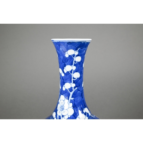 354 - A late 19th century Chinese blue and white globular vase, tianqiu ping, decorated with prunus on cra... 