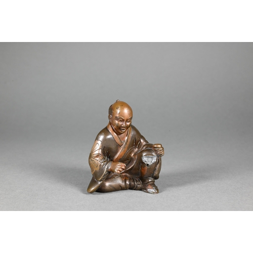 362 - A 19th century Japanese bronze okimono of a seated artisan, Meiji period (1868-1912) signed 火 用 (Bew... 