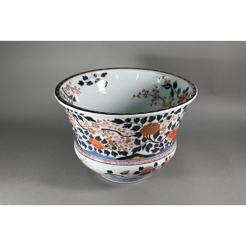 363 - A large 18th century Japanese Arita flared bowl, painted with a continuous design of peonies and pru... 