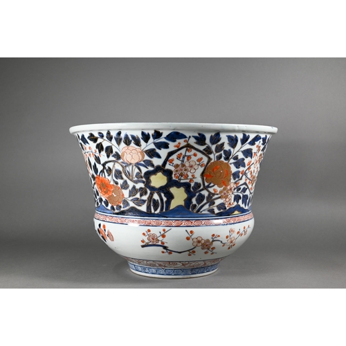 363 - A large 18th century Japanese Arita flared bowl, painted with a continuous design of peonies and pru... 