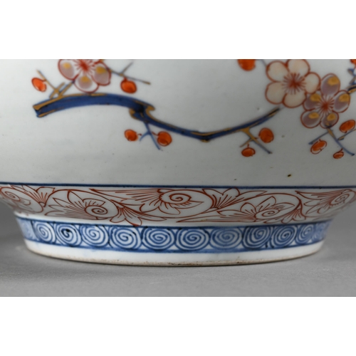 363 - A large 18th century Japanese Arita flared bowl, painted with a continuous design of peonies and pru... 