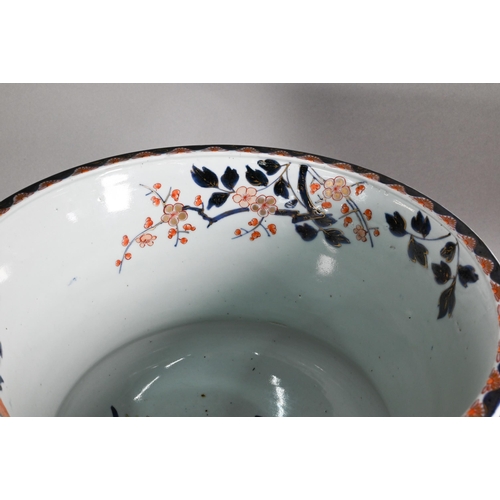 363 - A large 18th century Japanese Arita flared bowl, painted with a continuous design of peonies and pru... 