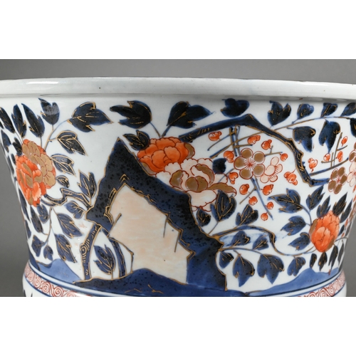 363 - A large 18th century Japanese Arita flared bowl, painted with a continuous design of peonies and pru... 