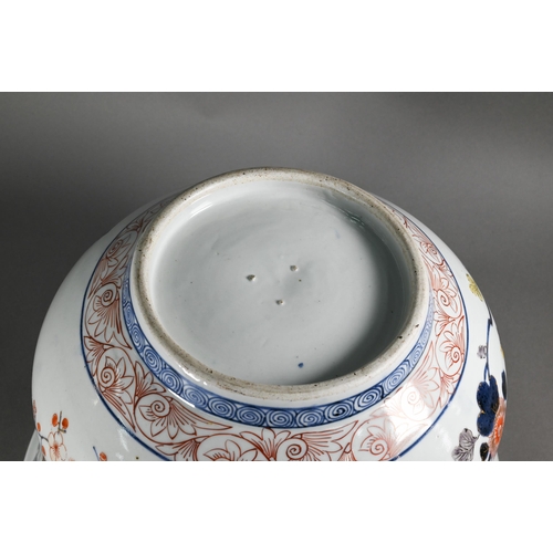 363 - A large 18th century Japanese Arita flared bowl, painted with a continuous design of peonies and pru... 