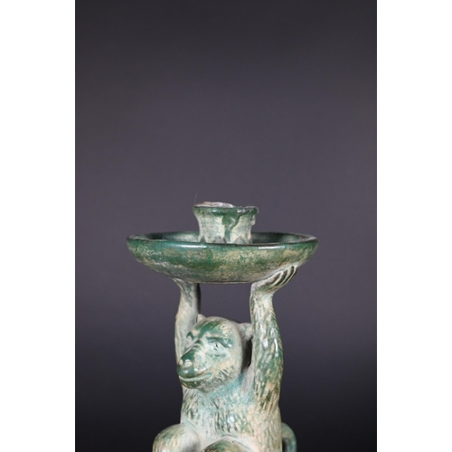 382 - A Chinese green glazed terracotta monkey candlestick with two character signature, 23 cm high