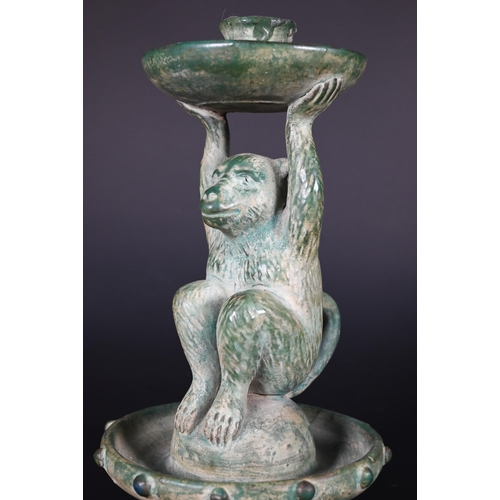 382 - A Chinese green glazed terracotta monkey candlestick with two character signature, 23 cm high