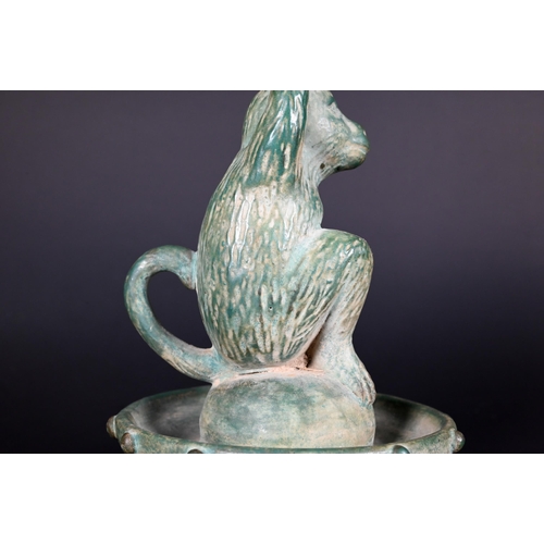 382 - A Chinese green glazed terracotta monkey candlestick with two character signature, 23 cm high