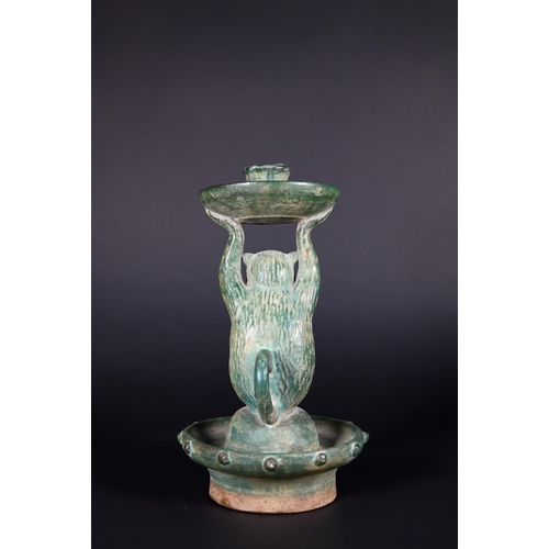 382 - A Chinese green glazed terracotta monkey candlestick with two character signature, 23 cm high