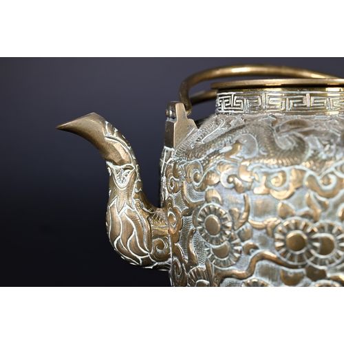 385 - A Chinese bronze twin-handled kettle or teapot with cover profusely chased and engraved with dragons... 