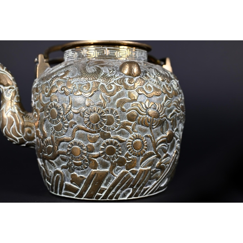 385 - A Chinese bronze twin-handled kettle or teapot with cover profusely chased and engraved with dragons... 