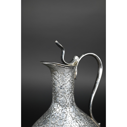 388 - A late 19th century Indian low grade silver moon flask ewer or claret jug, unmarked, finely chased a... 