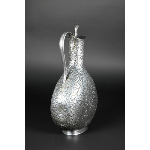 388 - A late 19th century Indian low grade silver moon flask ewer or claret jug, unmarked, finely chased a... 