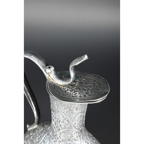 388 - A late 19th century Indian low grade silver moon flask ewer or claret jug, unmarked, finely chased a... 