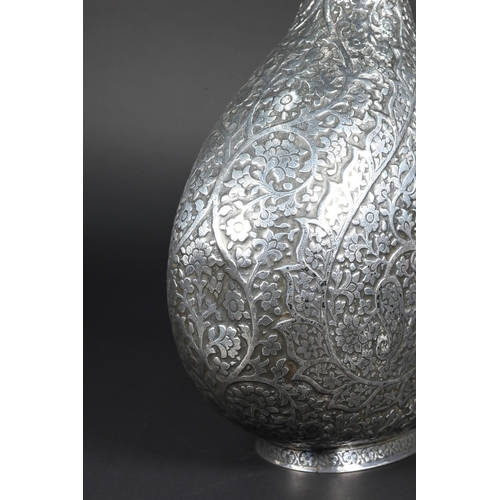 388 - A late 19th century Indian low grade silver moon flask ewer or claret jug, unmarked, finely chased a... 