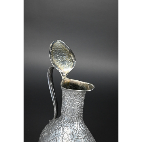 388 - A late 19th century Indian low grade silver moon flask ewer or claret jug, unmarked, finely chased a... 