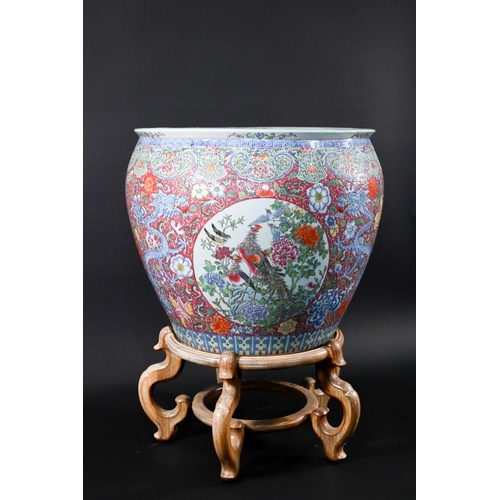 389 - A large Chinese famille rose fish bowl or jardiniere, painted in bright polychrome enamels with thre... 