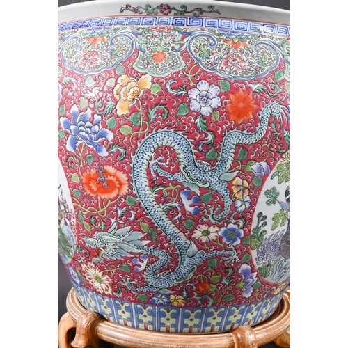 389 - A large Chinese famille rose fish bowl or jardiniere, painted in bright polychrome enamels with thre... 