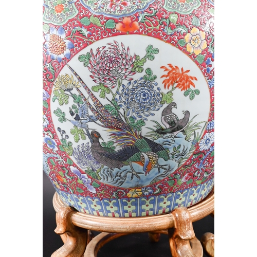 389 - A large Chinese famille rose fish bowl or jardiniere, painted in bright polychrome enamels with thre... 