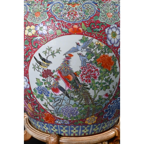 389 - A large Chinese famille rose fish bowl or jardiniere, painted in bright polychrome enamels with thre... 