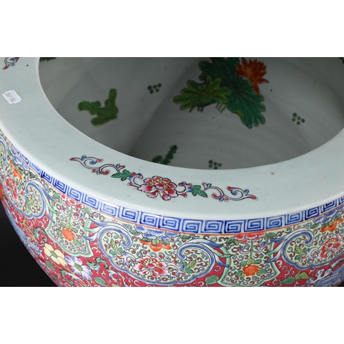 389 - A large Chinese famille rose fish bowl or jardiniere, painted in bright polychrome enamels with thre... 