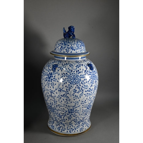 395 - A pair of 20th century Chinese blue and white temple jars and domed covers with karashishi lion fini... 