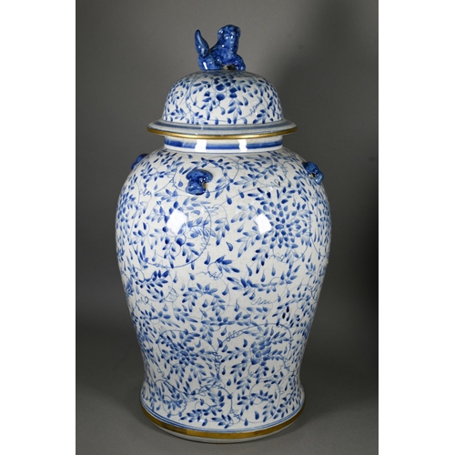 395 - A pair of 20th century Chinese blue and white temple jars and domed covers with karashishi lion fini... 