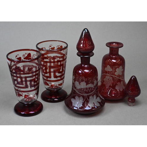 421 - A pair of 19th century continental ruby flash decanters with vine-etched decoration, 19.5 cm, to/w a... 