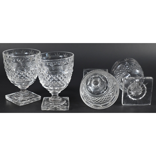 428 - A set of four Regency cut glass small rummers on stemmed and star-cut square bases, 8.5 cm (4)