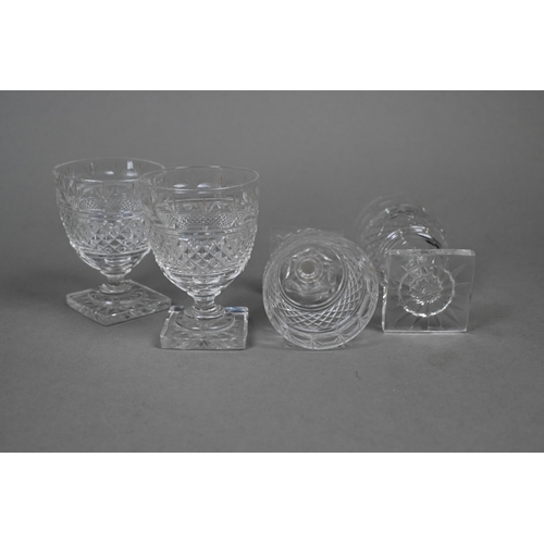 428 - A set of four Regency cut glass small rummers on stemmed and star-cut square bases, 8.5 cm (4)