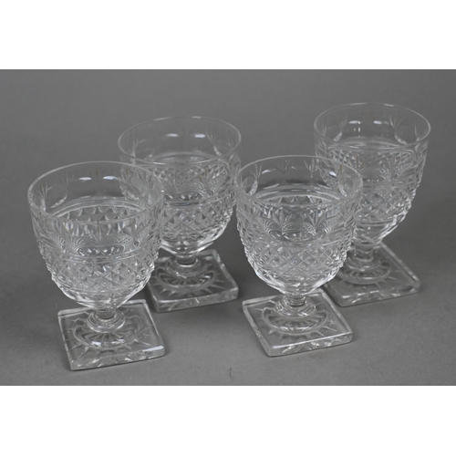 428 - A set of four Regency cut glass small rummers on stemmed and star-cut square bases, 8.5 cm (4)