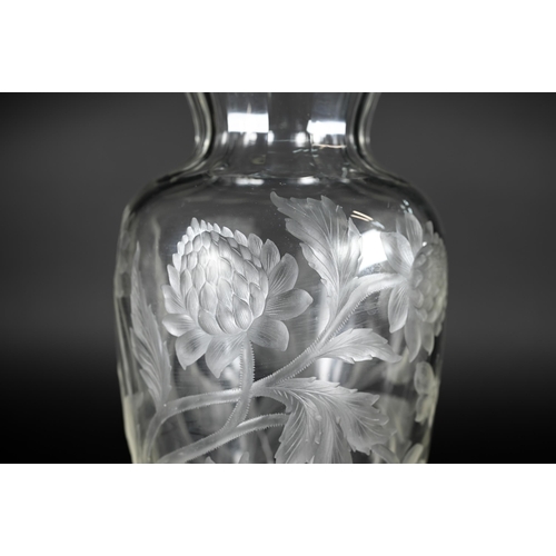 432 - A vintage glass vase, deep-cut with chrysanthemums and butterflies, 27 cm high