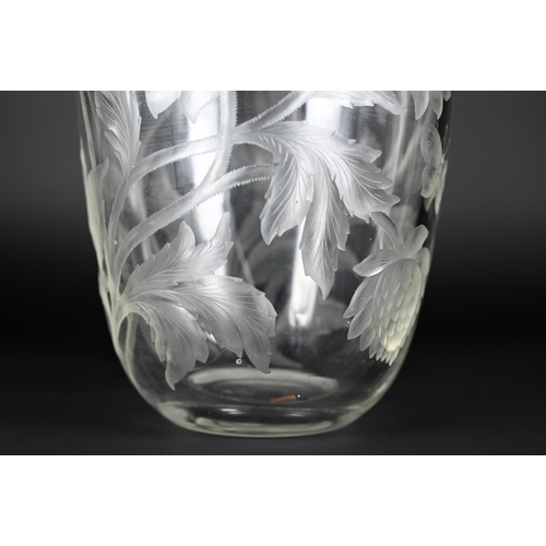 432 - A vintage glass vase, deep-cut with chrysanthemums and butterflies, 27 cm high