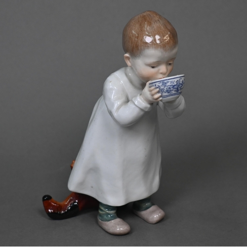 464 - A Meissen figure of a young boy drinking milk from a bowl, a toy horse at his feet behind, 16 cm hig... 