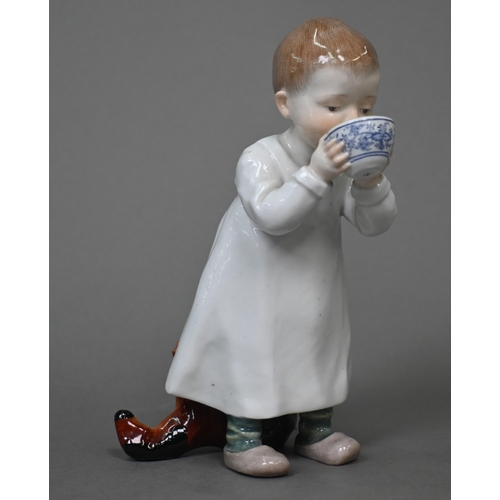 464 - A Meissen figure of a young boy drinking milk from a bowl, a toy horse at his feet behind, 16 cm hig... 