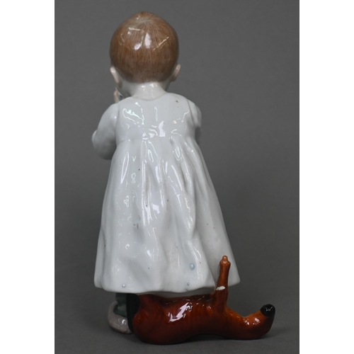 464 - A Meissen figure of a young boy drinking milk from a bowl, a toy horse at his feet behind, 16 cm hig... 