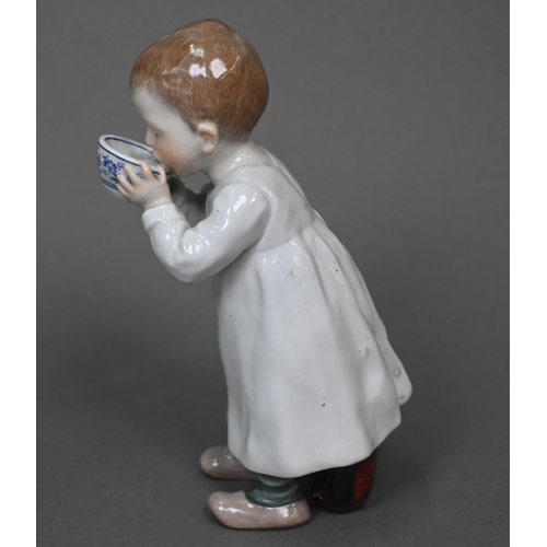 464 - A Meissen figure of a young boy drinking milk from a bowl, a toy horse at his feet behind, 16 cm hig... 