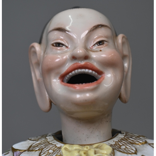 465 - A 19th century Meissen female nodding 'Pagoda' figure, seated cross-legged, with moving tongs and ha... 