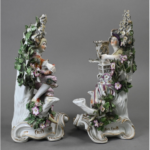 467 - A pair of Georgian Derby porcelain bocage groups/candelabra, modelled with a man with dog and bird, ... 