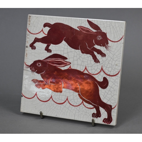 473 - A William De Morgan red lustre tile decorated with gambolling hares, 15.3 cm square