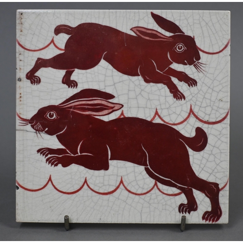 473 - A William De Morgan red lustre tile decorated with gambolling hares, 15.3 cm square