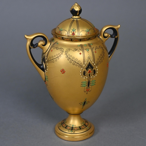 481 - A Royal Worcester small gilt urn and cover with twin handles and stemmed foot, the sparse foliate de... 