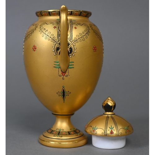 481 - A Royal Worcester small gilt urn and cover with twin handles and stemmed foot, the sparse foliate de... 