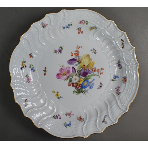 488 - A Meissen dish, painted with spray of flowers, insects and Deutscheblumen, within writhen rim with g... 