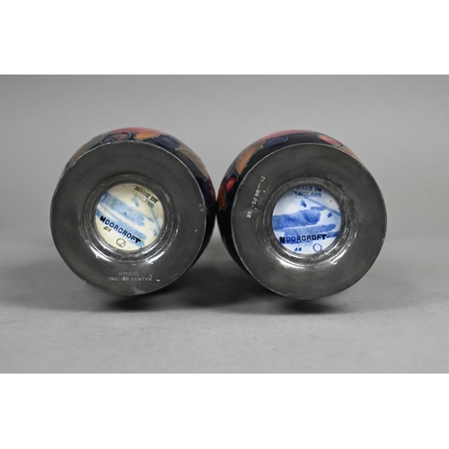 489 - A pair of Moorcroft 'Pomegranate' blue-ground baluster vases with hammered pewter bases stamped 'A. ... 