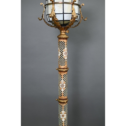 496 - A vintage continental (possibly Mettlach) gilt metal floor-lamp, 140 cm, with later marbled glass an... 